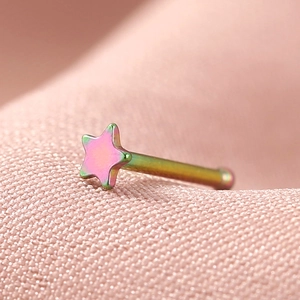 Macro shot of rainbow stainless steel star-shaped nose stud with polished finish