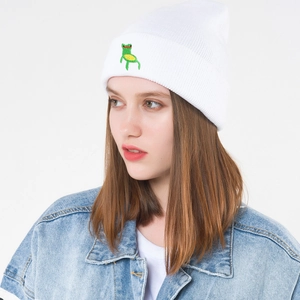 White ribbed knit beanie for women with cute green frog embroidery in a minimalist style