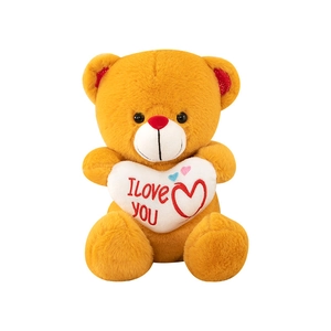 Brown teddy bear plush toy holding a white I Love You heart pillow on white background