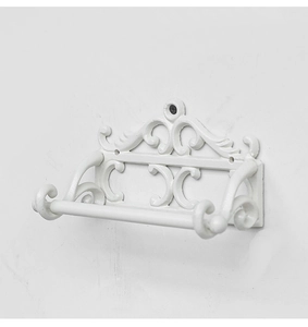Détail du porte-papier mural vintage en fer blanc avec des motifs ornementaux