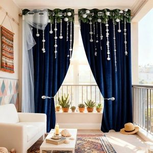 Detail of dark blue velvet curtain with decorative white bead tassels and grommet top