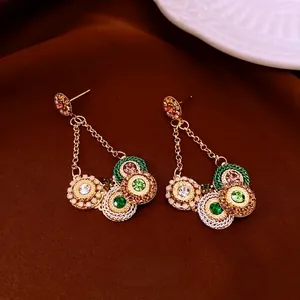 Vintage golden tassel earrings with colorful rhinestones and woven details
