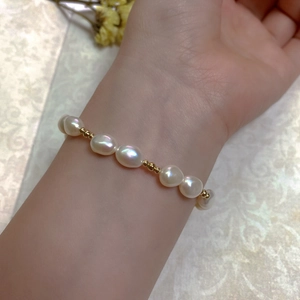 Detailed view of baroque pearl bracelet with 14K gold-filled beads on a wrist