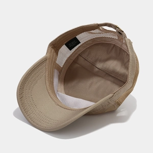 Inside view of khaki outdoor hat showing breathable mesh lining and adjustable metal buckle