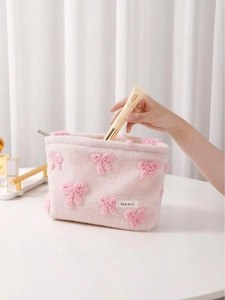 Sweet pink plush makeup bag with 3D bow and zipper closure for cosmetics storage