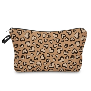 Detail of a brown leopard heart print toiletry bag with zipper and hand strap