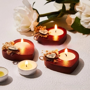 Detail of wooden heart candle holders with thank you tags and dried flower accents