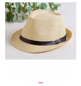 Dettaglio cappello fedora in paglia beige con cinturino in pelle nera e fibbia metallica