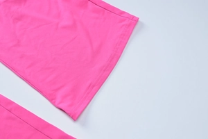 Close-up of pink flared trousers with professional double-needle stitching detail