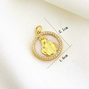 Detailed size view of gold religious pendant with relief figure and crystal inlay