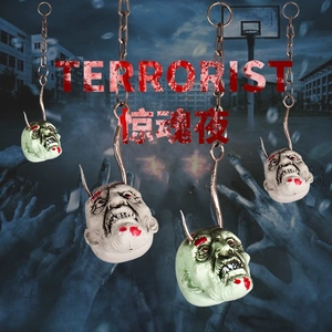 Halloween scary hanging prop featuring bloody zombie heads on large chains and metal hooks
