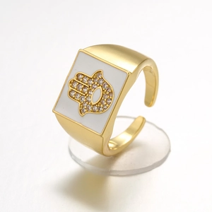 Adjustable golden Hamsa Hand ring with white enamel and sparkling rhinestones