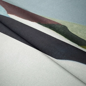 Macro detail of Bohemian woven tapestry featuring abstract landscape and thick fabric texture