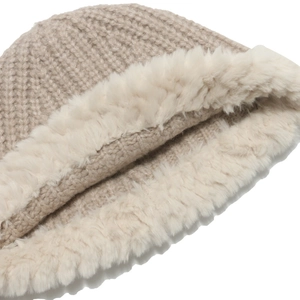 Close-up of thick beige knit and soft white faux fur trim on a winter bucket hat