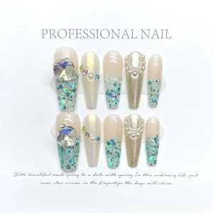 Handmade champagne glitter press-on nails with luxury crystals and pearls, long coffin shape