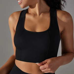 Close-up of black seamless sports bra featuring breathable honeycomb texture and knit details
