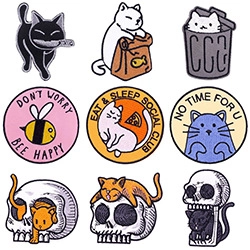 Detailed set of nine colorful cartoon cat and skull enamel pins with metal edges