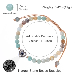 Amazon stone beaded bracelet with silver heart projection pendant and woven adjustable cord