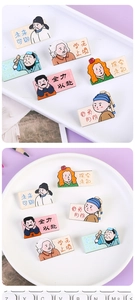 Detailed close-up of cartoon celebrity acrylic badges with motivational Chinese text