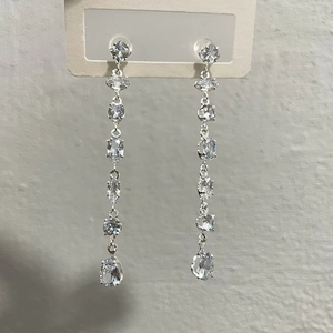 Close-up of elegant silver tassel drop earrings with sparkling rhinestone crystals