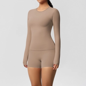 Detailed texture of mocha-colored matte fabric on tight-fit long-sleeve yoga set