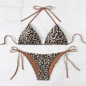 Classic leopard print bikini set with halter top and side-tie bottoms on textured background