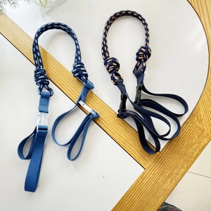 Detail of woven nylon pet leash with adjustable plastic buckle on wooden background