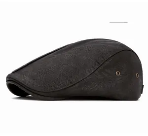 Close-up of grey leather newsboy cap showing metallic eyelet and stitched texture detail