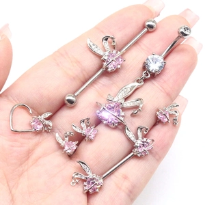 Pink rabbit piercing jewelry set with heart-shaped zircon on palm for detail