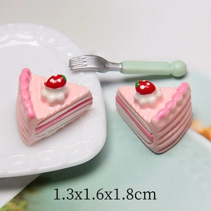Macro shot of miniature resin strawberry sandwich cake model on a white vintage plate