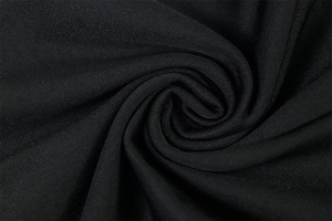 Macro shot of black high-density textile fabric with flexible texture and drape detail