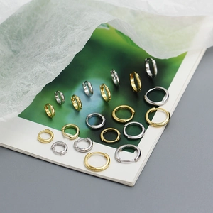 Close-up of S925 sterling silver and gold geometric hoop earrings in various sizes