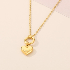 Close-up of golden 3D heart pendant necklace with polished finish and classic O-chain