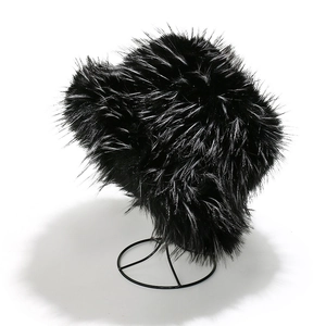 Macro detail of plush faux fox fur texture on a thick black winter bucket hat