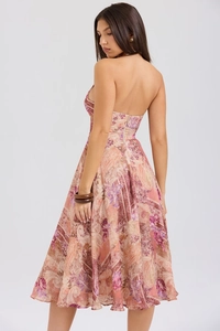 Back view of pink paisley halter dress showing open back design and A-line silhouette