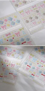 Detailed close-up of 3D embossed nail art stickers featuring colorful bows and lace