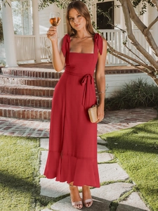 Detail of burgundy maxi dress with adjustable shoulder bow ties and ruffled hemline