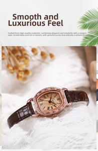 Macro detail of tonneau watch with rose gold case and brown leather strap on soft fabric