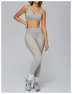 Close-up of heather grey high-waist yoga pants and V-neck sports bra with ribbed texture