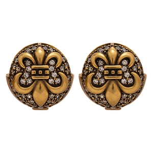 Vintage gold fleur-de-lis earrings with shimmering zircons in a retro star design