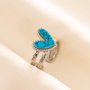 Macro shot of heart-shaped blue turquoise ring with silver filigree adjustable band