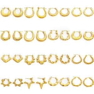 Collection of golden titanium steel hoop earrings in various vintage textured designs