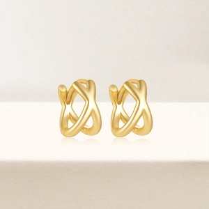 Close-up of golden S925 silver double-row cross hoop earrings with turquoise accents