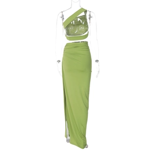 Detail of green two-piece set featuring a one-shoulder crop top and side slit maxi skirt