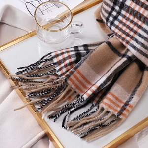 Classic Australian wool plaid scarf with orange and camel check patterns and fringed edges