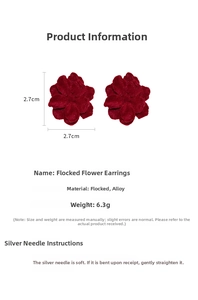 Detail view of 2.7cm red flocked flower earrings with silver needles and alloy material