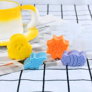 Halloween silicone molds set featuring ghost, bat and spider web shapes on plaid decor