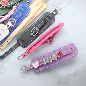 Close-up of colorful DIY PU leather keychains with metal buckles and decorative charms