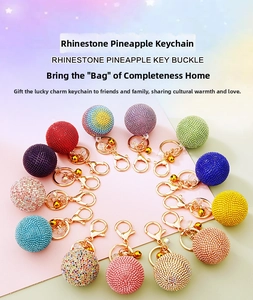 Detailed overhead view of fourteen rhinestone ball keychains in multiple vibrant colors