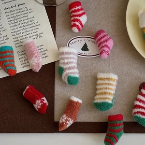 Detailed view of colorful mini knitted Christmas stockings for DIY holiday decorations